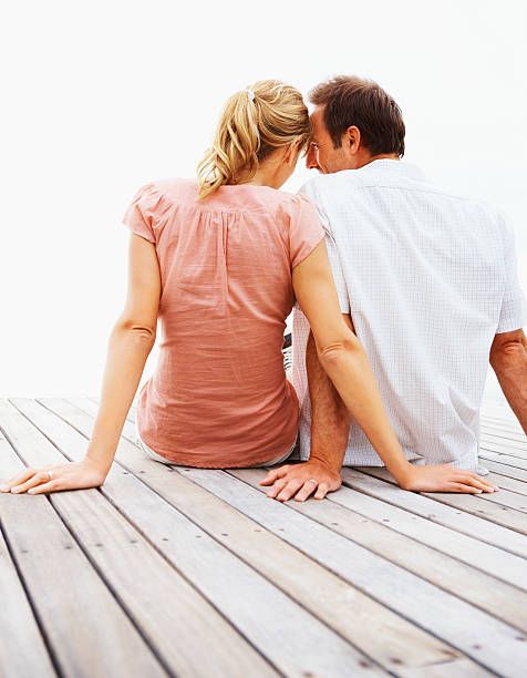 istock Young couple romancing on pier 171147534
