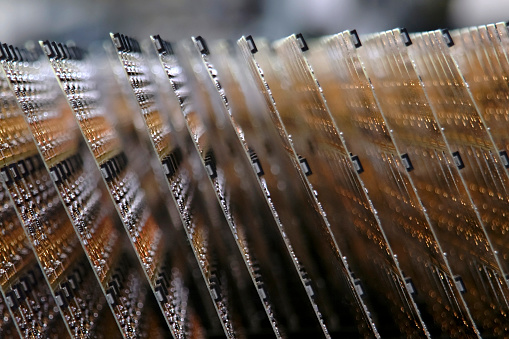 Electronic circuit boards stacked on an assembly line. Shot with shallow depth of field.