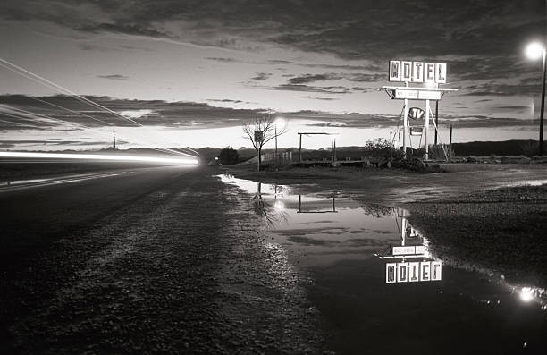 motel, retro - paris,texas motel paris, texas - where wim wenders shot the "paris texas" motel scene, after storm passed by, long time exposure, truck is passing leaving light traces over wet asphalt motel stock pictures, royalty-free photos & images