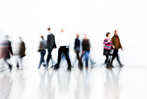istock Motion Blurred Pedestrians Rushing In Front Of White Wall 171147780
