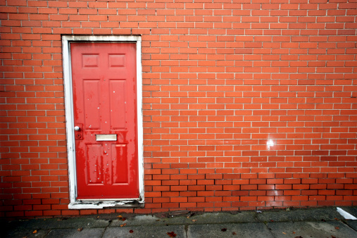 Urban red door gunshot with wall copy space
