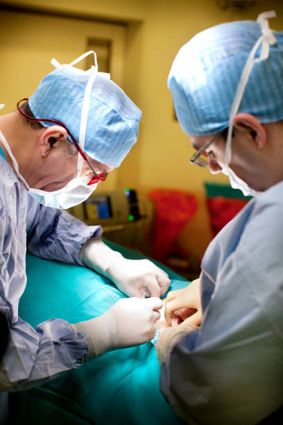 Doctors performing surgery stock photo