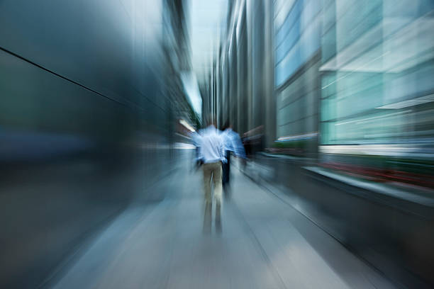 istock Businessmen Walking Down Futuristic Passage in Financial District 171148558