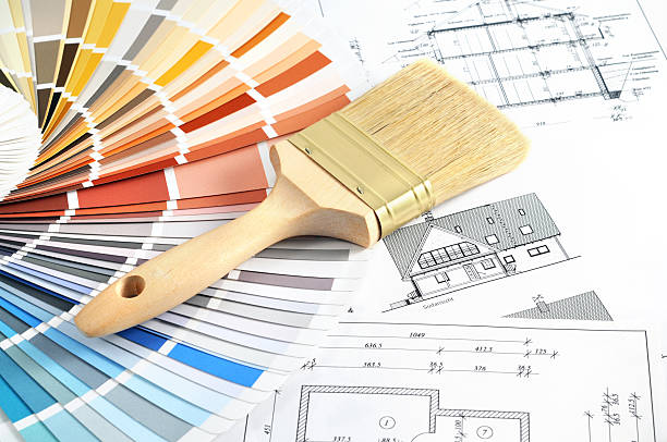 istock A paintbrush and paint swatches laying on design blueprints  171148799