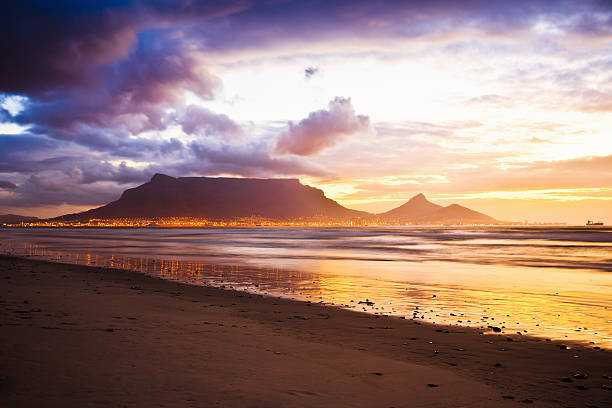 Cape Town Table Mountain Sunset Beach South Africa Cape Town Table Mountain Twilight Sunset Scene, view from Sunset Beach. Long exposure. table mountain south africa stock pictures, royalty-free photos & images
