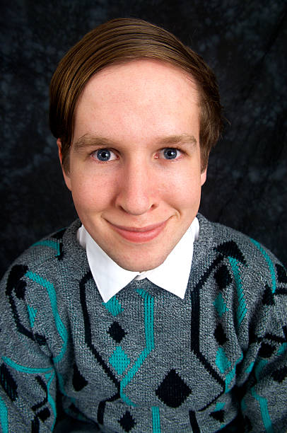 Geek Young man aged 18 to 20 years in retro style jumper and combed over hair, head and shoulders portrait, looking like a nerd.More like this: comb over stock pictures, royalty-free photos & images