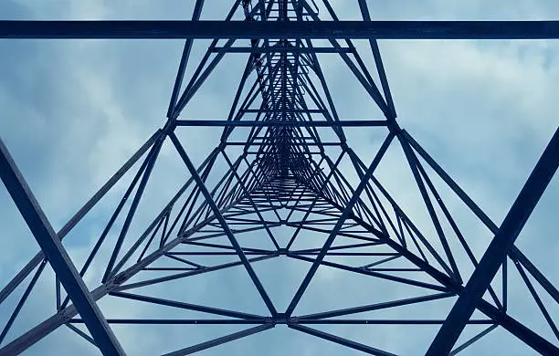 Looking directly up the middle of a communications tower.