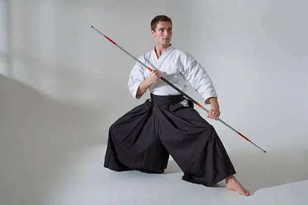 Young man with Kendo pants and Bo Staff