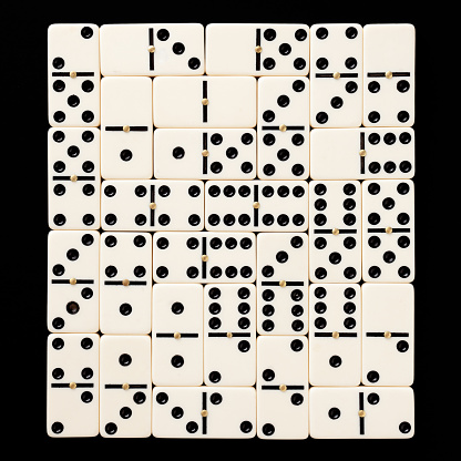 Domino pieces arranged in square shape over black background