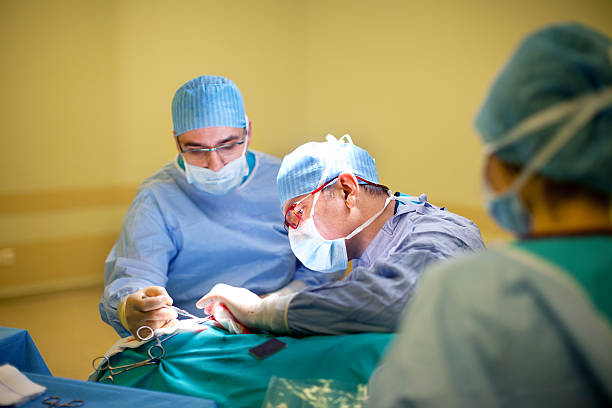 Doctors performing surgery stock photo