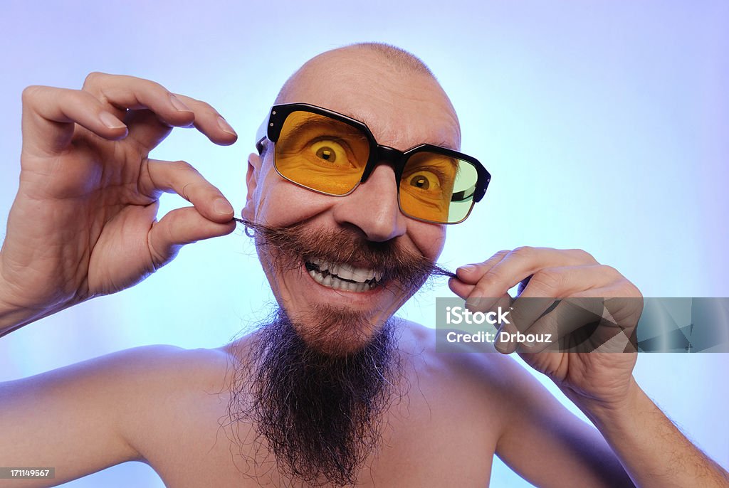 man with beard bald ugly man with funny mustaches and beard making a grimace, holding mustaches. high distortions due uwa lens Jester Stock Photo