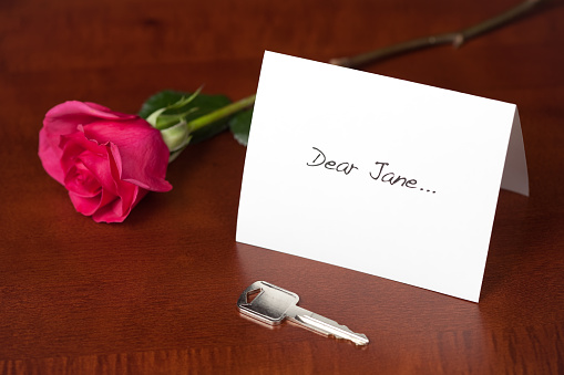 Opposite of a 'Dear John' letter, in this scenario a man breaks the relationship leaving behind a note, key and rose. Focus is on the 'Dear Jane'.Here are some similar Dear John/Dear Jane images: