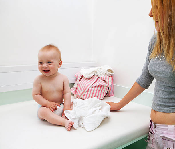 Young mother with her child at pediatrician waiting for exam