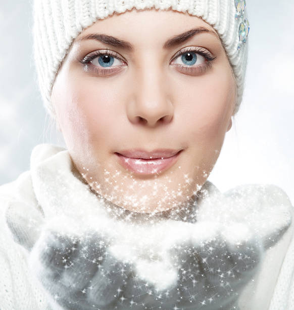 istock winter woman blowing a snow to camera 171149858