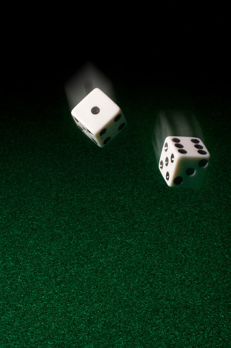 rolling dice on green felt - note natural and added motion blur
