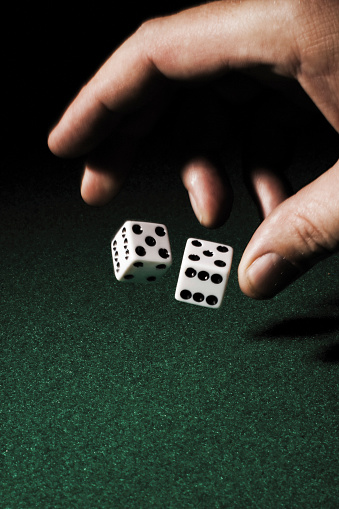 rolling dice on green felt - note some motion blur