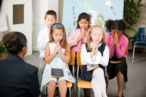 A group of multi-ethnic children at Sunday School in a real church classroom 