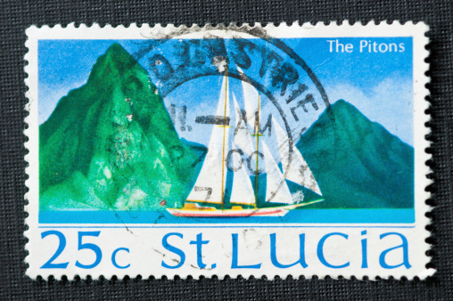 A 25 cent post stamp from St. Lucia showing a sail yacht and the Pitons