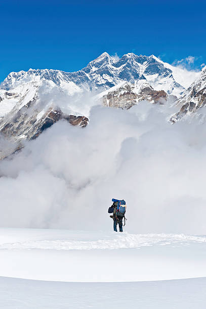 Photo of Sherpa mountaineer climbing below Mt Everest mountain summit Himalayas Nepal