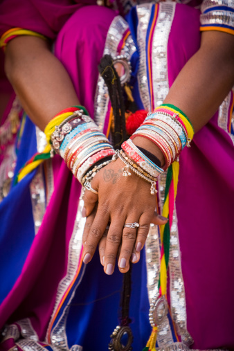 indian girl with bracelets ad colourful dress.