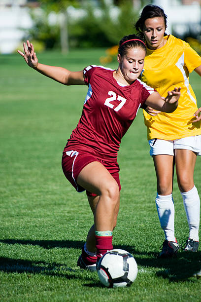 istock Female Soccer Player Breaks Away From Defense 171150739