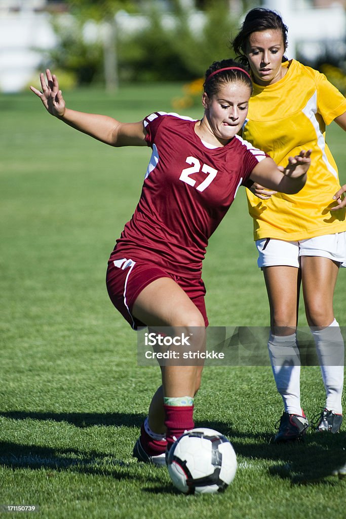 Female Soccer Player Breaks Away From Defense A dynamic female soccer player in traffic.RELATED IMAGES: Activity Stock Photo