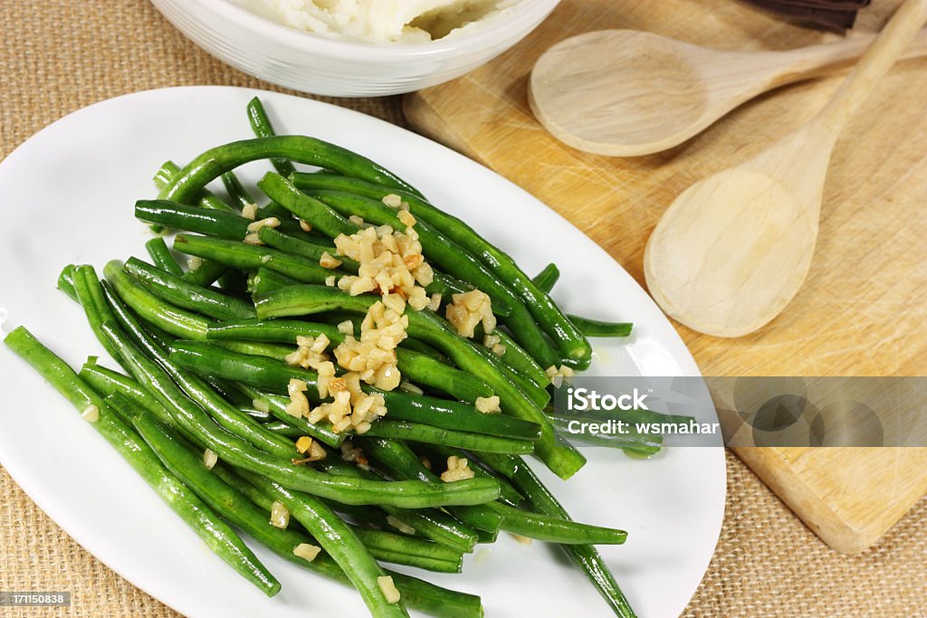 Fresh green beans serves with crushed nuts Whole Green beans sautéed with olive oil and garlic Green Bean Stock Photo