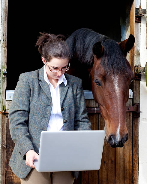 istock young woman with computer and horse 171150997