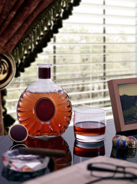 istock One Glass of Cognac and Bottle on Table by Window 171151188
