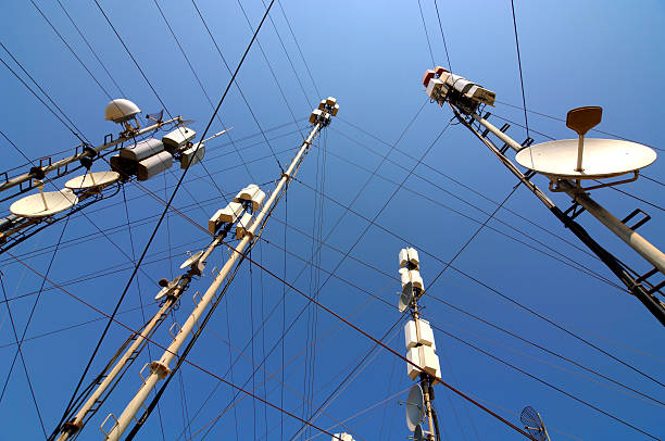 Telecommunication masts and satellites seen from below stock photo