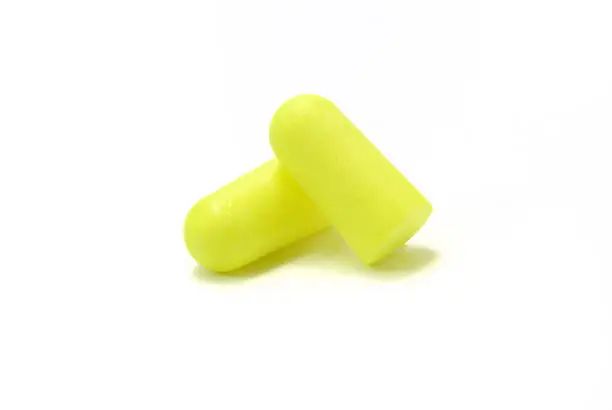 Two disposable ear plugs for hearing protection.