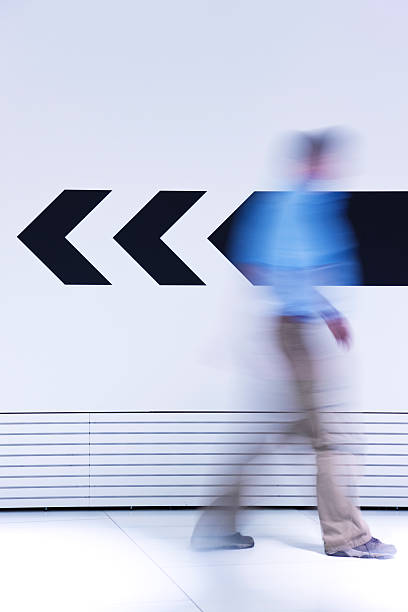 istock Man walking in opposite direction of arrow 171151593