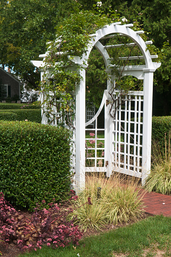 A gated garden arch at the entrance to a formal garden in  Massachusetts.