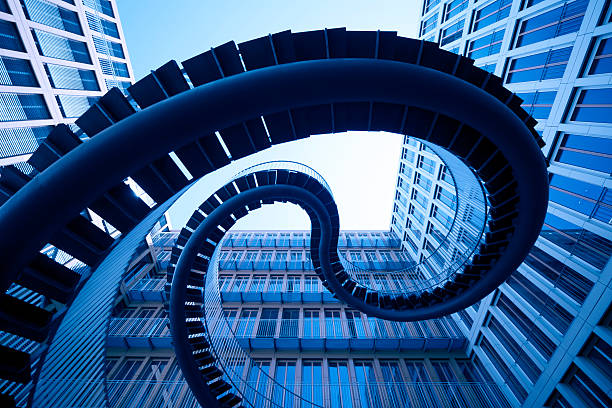 spiral stiars in front of modern architecture XL - spiral stairs in front of an modern office building - camera canon 5D  - unsharped RAW  - adobe colorspace below photos stock pictures, royalty-free photos & images
