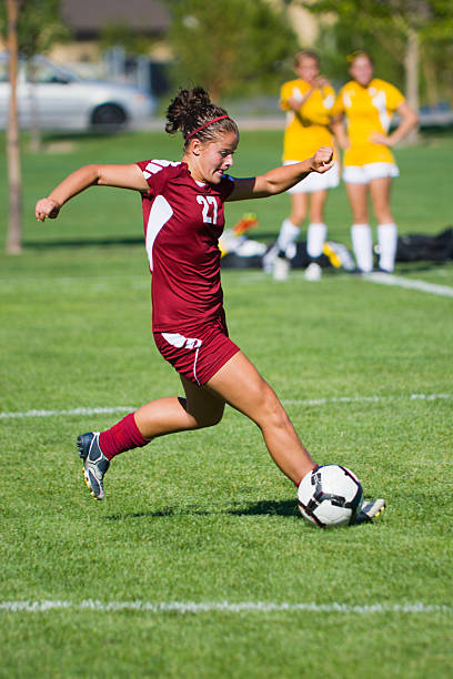 istock Dynamic Female Soccer Player Pounces in front of Rolling Ball 171151742