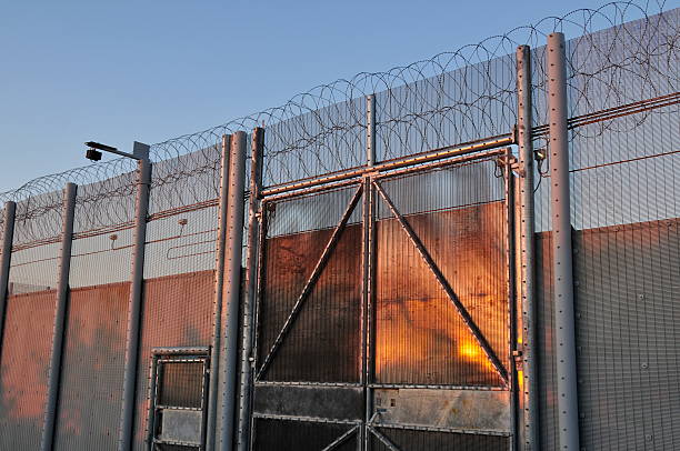 Prison,Jersey. Telephoto image of prison security at dusk. barbed wire photos stock pictures, royalty-free photos & images