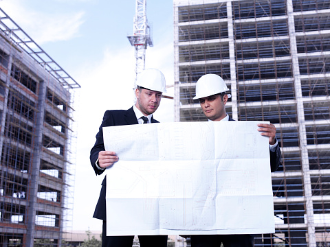 Engineer, tablet and man at construction site for development with mockup. Architecture, 5g technology and happy male contractor or architect with touchscreen for web scrolling or internet browsing.