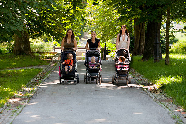 Young mothers in a park walking their babies