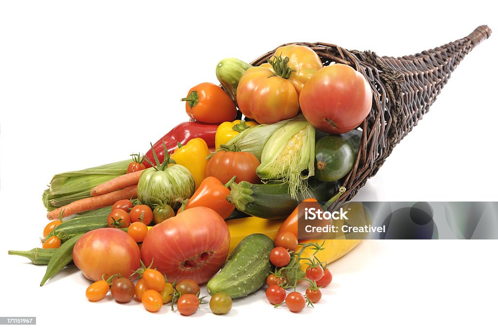 Cornucopia with home grown vegetables Assorted home grown vegetables in a horn basket - heirloom and miniature tomatoes, peppers, cucumbers, zucchini, corn, carrots, okra Vegetable Stock Photo