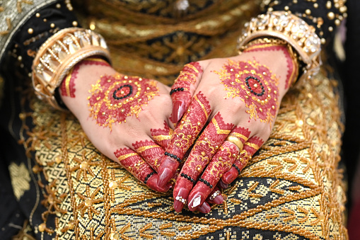 Henna and false nails on bride's hands