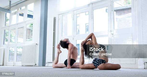 Man And Woman Performing Yoga Pigeon Pose Stock Photo - Download Image Now - 30-34 Years, 30-39 Years, Adult