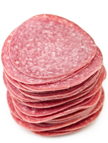 Stack of italian sliced salami on white background (this picture has been taken with a super high definition Hasselblad H3D II 31 megapixels camera)
