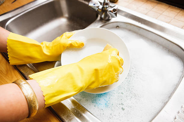 istock Woman's hands in rubber gloves doing the dishes 171152478