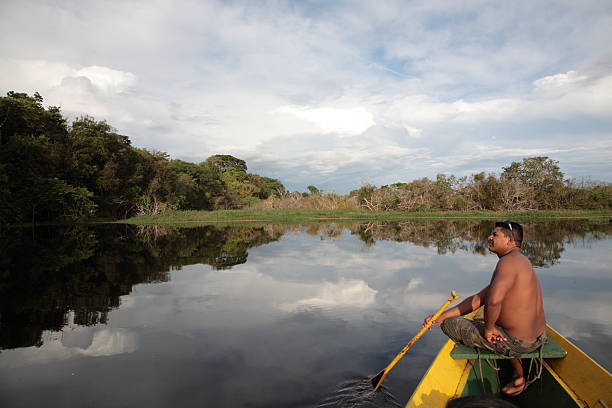 istock Shirtless man admiring a view of the Amazon River 171152868