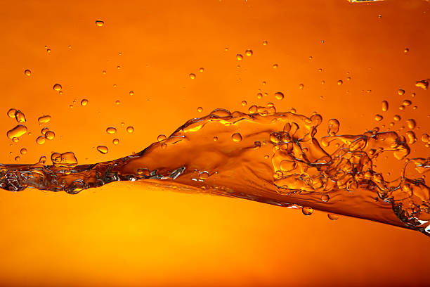 Wave orange Water splash caught in action. Shot on Canon EOS 1Ds mark 3 crude oil photos stock pictures, royalty-free photos & images