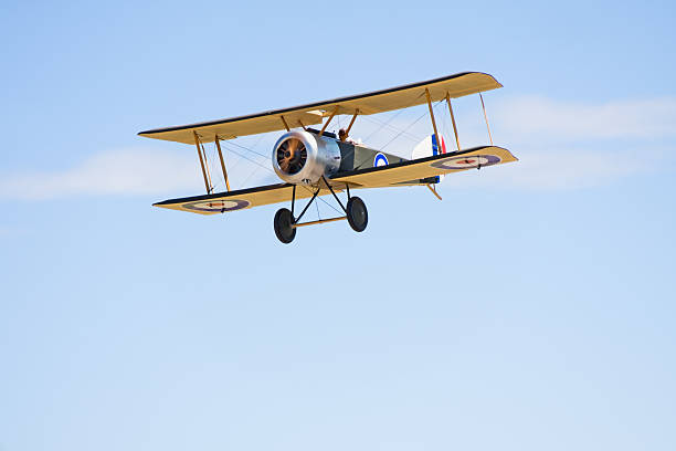 Remote Control Biplane in Flight A remote control biplane in flight. toy airplane stock pictures, royalty-free photos & images
