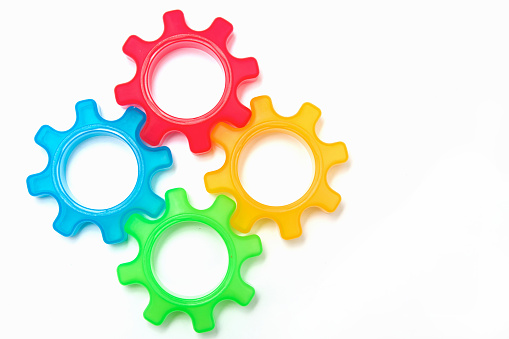 a colorful gearing system connected on a white background.