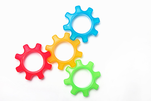 a colorful connected gearing system on a white background.