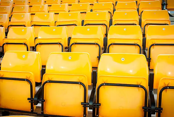 Photo of football stadium yellow seats in norway