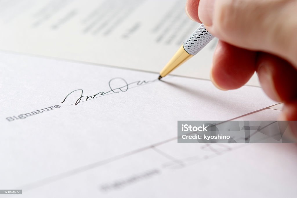 Close-up of signing a contract with shallow depth of field Close-up of signing a contract with shallow depth of field.  Signing Stock Photo